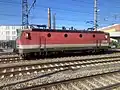 1144 052 in a train yard; this locomotive has the original (smaller) ventilation intakes on the sides