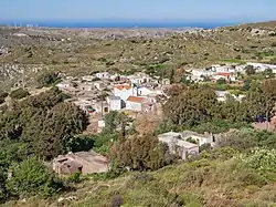 The village, situated below the crest of a ridge, photographer looking north to the sea of Crete from a high point of the Zakros mountains.