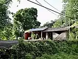 The Kong-kài (left) and the tribal gathering place (right) of Hiám-thâm.