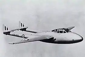 Single-engined military jet with twin tailbooms in flight