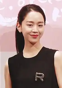 Shin in black dress posing for a camera in May 2019