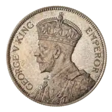 A crowned portrait of George V in royal dress, with the encircling text GEORGE V KING to the left, and EMPEROR to the right.