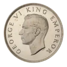 A crowned portrait of George V in royal dress, with the encircling text GEORGE V KING to the left, and EMPEROR to the right.