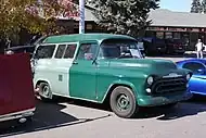 A bad-condition 1957 Chevrolet Suburban with dual color