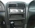 The center console of a 2000 SVT Cobra R with the deleted radio and A/C, but modified with aluminum knobs.