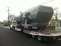 Rear view, loaded onto a heavy duty trailer for transport