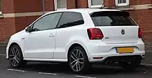  Rear-three quarter view of a three-door car with twin exhaust pipes