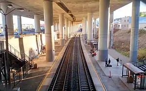 A railway station under an elevated highway