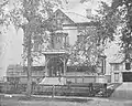 This house, at 261 Main Street, was built in 1879 as the home of Sylvanus Cushing Blanchard. Camp Hammond is visible in the background on the left. The carriage house on the right is now the parking lot of InterMed