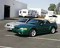 A stock 1999 SVT Cobra convertible. Note the original chrome headlights and wheels.