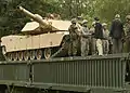 Soldiers of the 9th Engineer Battalion and the 701st Panzer Pioneer Battalion meet on a bridge constructed in Grafenwoehr during training, 24 August 2010.