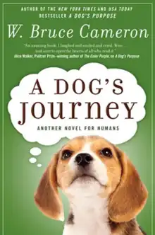 A beagle puppy with a think bubble containing the text "A Dogs Journey", with the text "Sequel to New York  Times and USA Today Bestseller A Dog's Purpose" above the bubble on a green background