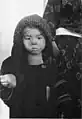 A boy holding a rice ball, which is one of Yamahata's famous photos