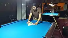 Image 5A player racking the balls (from Pool (cue sports))