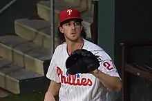 Aaron Nola sitting, glove extended.