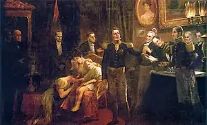 A painting showing a crowded room in which a uniformed man hands a sheaf of papers to another uniformed man while in the background a weeping woman sits in an armchair holding a young boy before whom a woman kneels