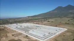 Aerial view of a prison near a volcano in an isolated area