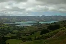 View of Akaroa harbour; the long, thin peninsula extending out into the harbour is Ōnawe Peninsula, and the middle of the volcano