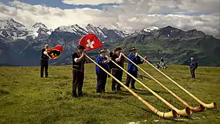 Image 18Some of the traditional symbols of Switzerland: the Swiss flag, the alphorn and the snow-capped Alps (from Culture of Switzerland)