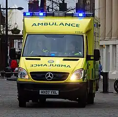 Mirror anamorphosis on the lower front of an ambulance, so the writing appears right way round in rear view mirrors of vehicles ahead of it in traffic