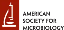 A stylized illustration of a microscope in white on a brick red background, beside the text: American Society for Microbiology