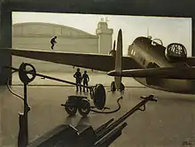 In an almost monochromatic composition, a World War Two twin-engined bomber is seen silhouetted against its open hangar door