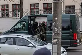 A minivan with armed troopers