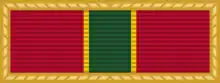 Width-44 red ribbon surrounded by gold frame. The ribbon has a central width-8 green stripe flanked by a pair of width-1 yellow stripes.