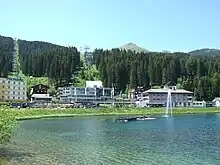 A view of the railway station, with the Obersee in the foreground and the cable car behind