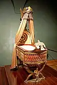 King of Rome's Cradle; by Pierre-Paul Prud'hon, Henri Victor Roguier, Jean-Baptiste-Claude Odiot and Pierre-Philippe Thomire; 1811; wood, silver gilt, mother-of-pearl, sheets of copper covered with velvet, silk and tulle, decorated with silver and gold thread; height: 216 cm; Kunsthistorisches Museum, Vienna, Austria