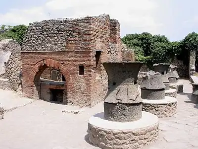 Millstones made of two elements of volcanic lava. Bakery in Pompeii.