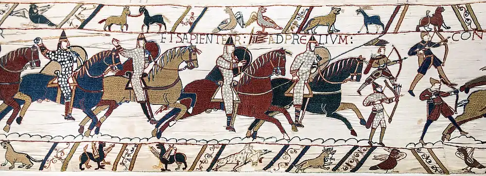 Norman archers depicted in the Bayeux Tapestry.  The top left archer was caught unprepared and has hastily thrown his belt quiver about his shoulders, as well as forgetting his helmet.