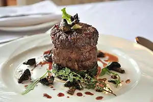 A beef fillet garnished with sautéed mushrooms