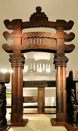 Eastern gateway of Bharhut stupa topped with a dharmachakra pinnacle