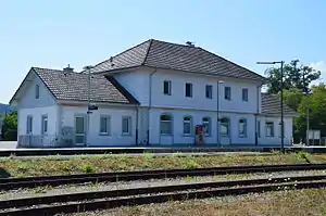 Two-story building with hipped roof and wings