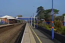 Bicester North railway station showing buildings, platform, and gardens