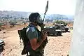 A Border Policeman in a tear gas mask.