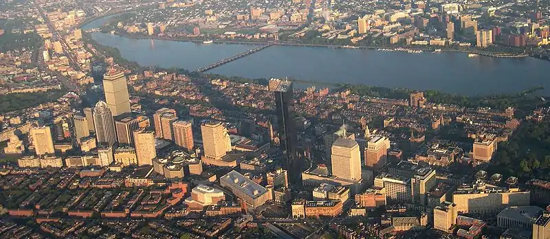 A cityscape including a number of skyscrapers, with a river running through the middle