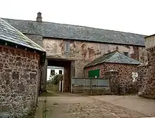 Old stone building with archway.