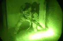 A ballistic breach at night of a padlocked door