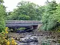 The river is tidal at this point. The old bridge to Ardgowan can also be seen.