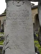 detail of memorial in cemetery, giving dates of birth and death for Harris and his wife.