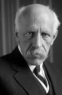 Nansen shown in later years with white, receding hair; characteristic drooping white mustache; and intensely focused eyes.