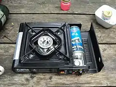 Camp  stove with can of butane fuel