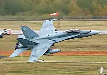 A fighter jet taking off from a runway