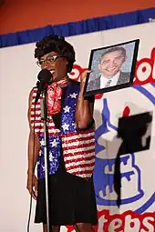 Woman holding a picture of Barack Obama