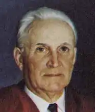 painting of the head and neck of an older white man, he has short hair and is wearing a club tie