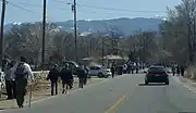 Walkers in front of the Holy Family church