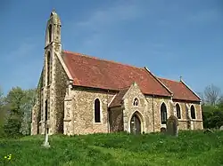 A simple stone church, consisting of a nave and chancel, viewed from the south-west