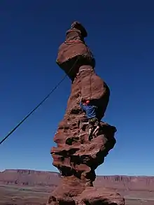 Climber ascends the Corkscrew pitch on Stolen Chimney